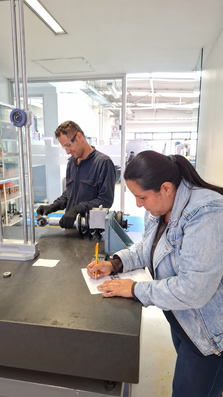 Engineer Liliana Vanegas documenting a factory inspection of a suspension assembly